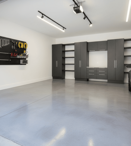Residential garage with silver-gray polished concrete floor, satin finish, and refined industrial style.